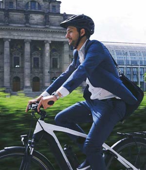 Commuter riding an electric bike in suit